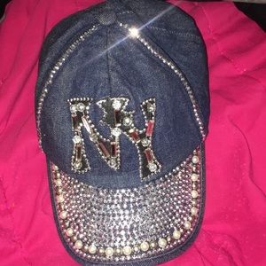 Studded, crafted “NY” symbol baseball cap .